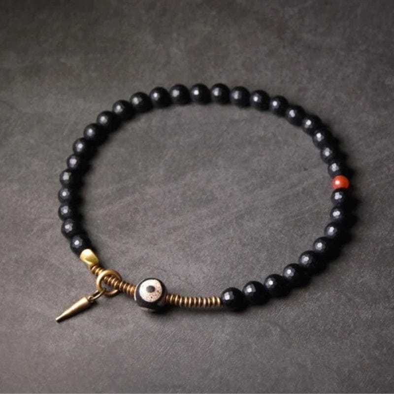 Kalachakra - Bracelet en onyx facetté, perle dzi et cuivre tibétain