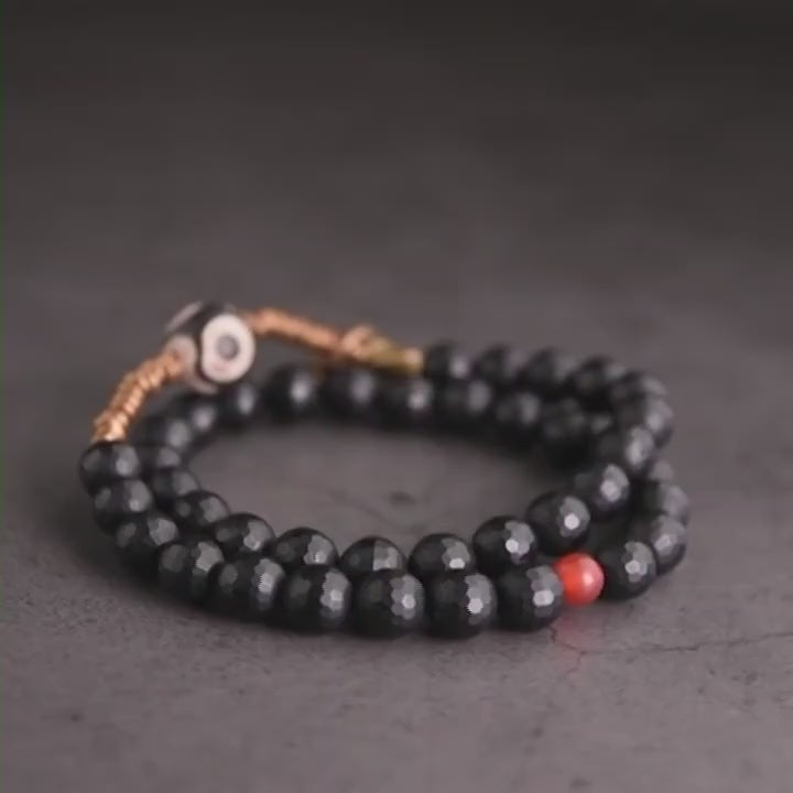 Bracelet en onyx facetté, perle dzi et cuivre tibétain